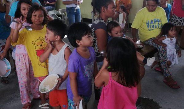 Children lining up to receive a meal
